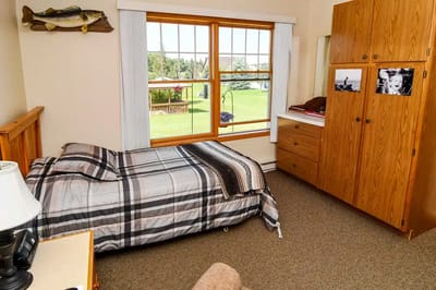 Private room with a bed and dresser