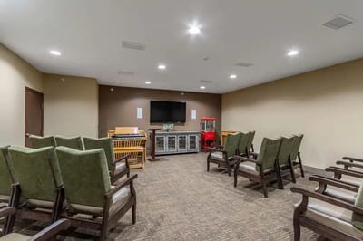 Bright activity room with seating and entertainment options