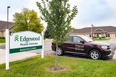 Facility signage with vehicle parked outside
