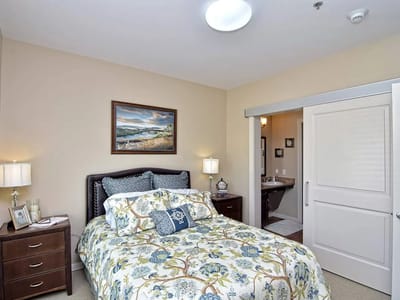 Cozy private bedroom with floral bedding and artwork