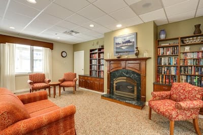 Cozy interior common area with seating and bookshelves