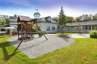 Outdoor playground area with building in the background