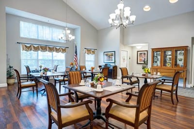 Interior view of a bright dining room with tables and chairs