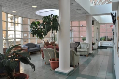 Bright common area with seating and plants.