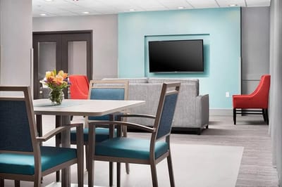Bright lounge area with seating and a TV