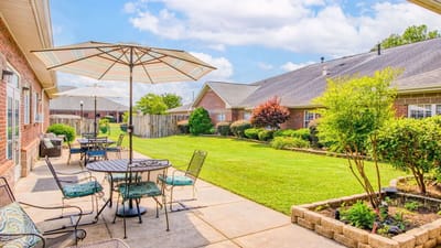 Outdoor seating area with umbrellas and landscaped garden