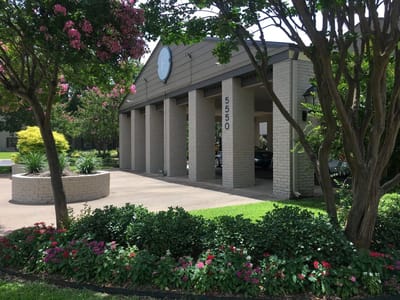 Covered entrance of a senior living facility with landscaping