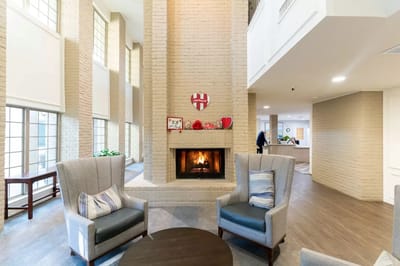 Common area with seating around a fireplace and decorative elements