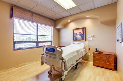 Private resident room with hospital bed and window