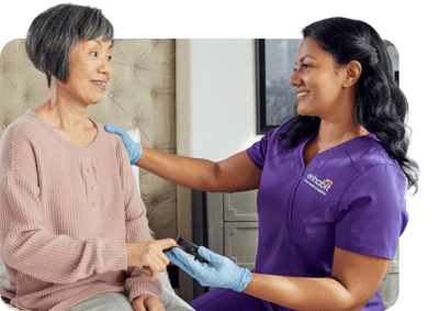 A caregiver interacting with a resident in a facility room