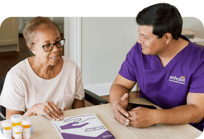 Resident engaging with staff in an activity