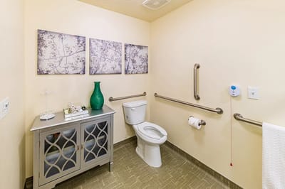 Clean bathroom with decorations and safety features