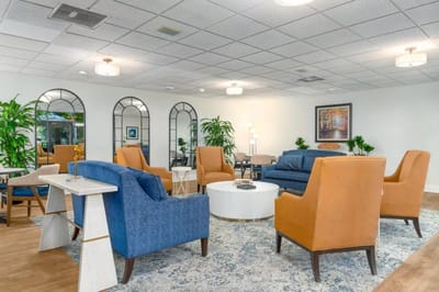 Bright common area with comfortable seating and plants