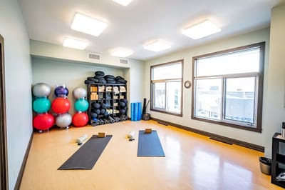 Interior view of a fitness room with yoga mats and exercise equipment