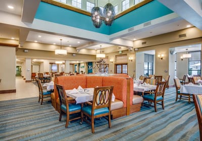 Dining area with tables and chairs set for meals