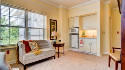 Cozy interior of a resident's suite with seating area