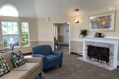 Bright common area with seating and fireplace