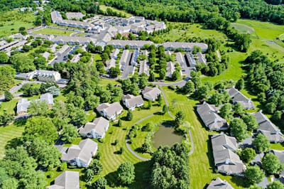 Aerial view of a senior living community with landscaped grounds