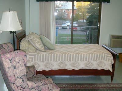 Cozy bedroom with a bed and chair