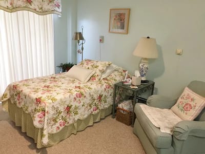 Cozy resident room with floral bedding and seating area