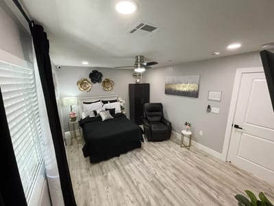 A cozy private resident room with a bed and chair