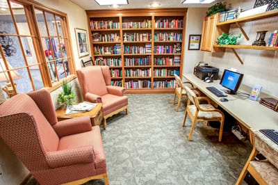 Cozy library area with bookshelves and seating