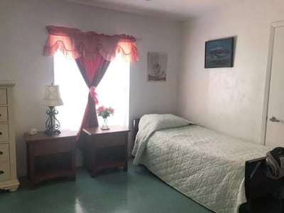 A private resident room with a bed and furniture