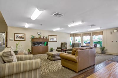 A cozy common area with seating and decorative plants