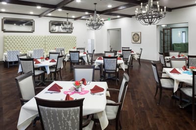 Bright dining room with tables set for residents