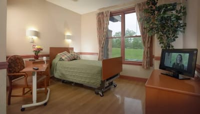 Private resident room with a bed and TV