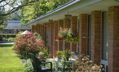 Outdoor seating area with flowers and greenery