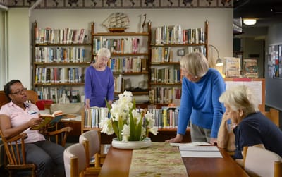 Residents engaging in the facility library area