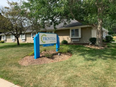 Exterior view of Frontida Assisted Living: Azalea Place with signage.