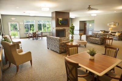Bright common area with seating and a fireplace