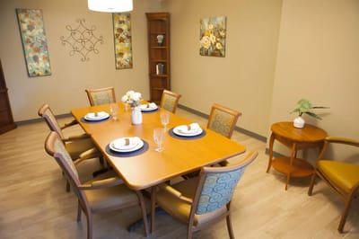 Tastefully arranged dining room with flowers and dinnerware