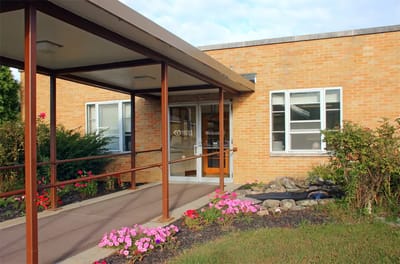 Entrance of a rehabilitation center surrounded by flowers