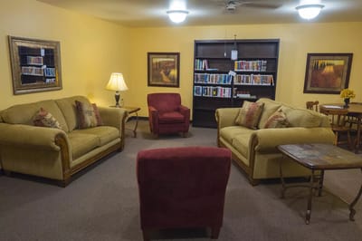 Cozy common area with seating and a bookshelf