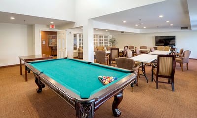 Interior of a common area with a pool table and seating