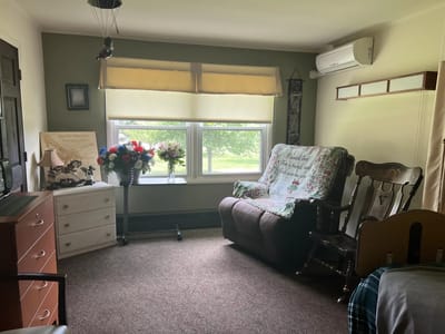 Cozy resident room with comfortable chair and decorations