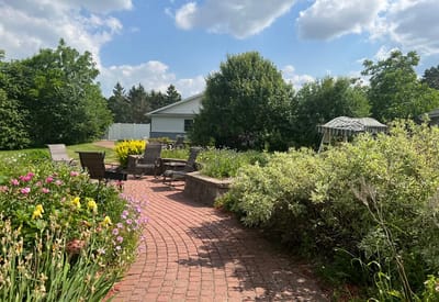 A tranquil garden space with seating and blooming flowers
