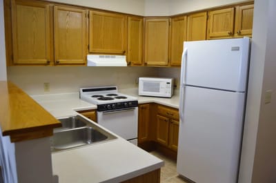 An interior view of a kitchen with oak cabinets
