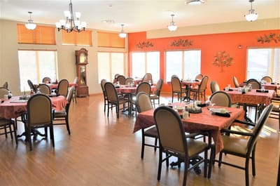 Bright dining area with tables set for residents