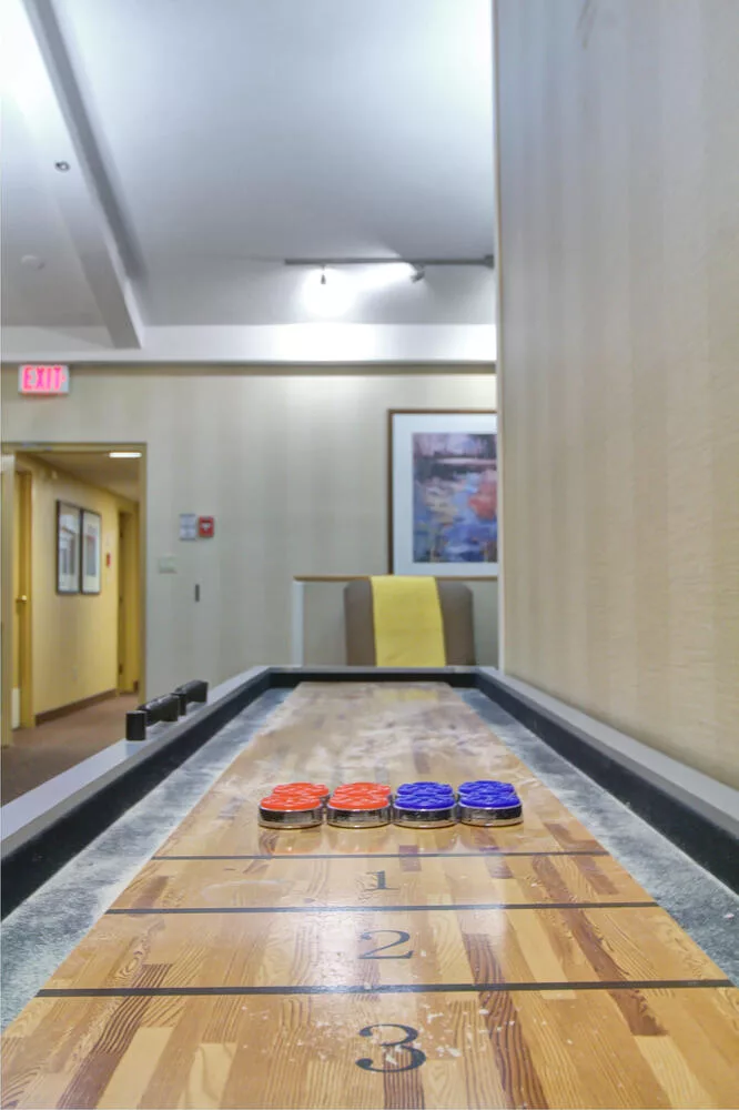 Indoor shuffleboard court with game accessories