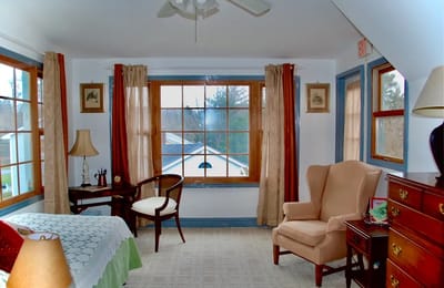 Cozy resident room featuring a bed and seating area