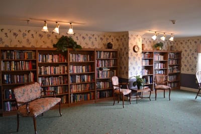 Cozy library space with bookshelves and chairs