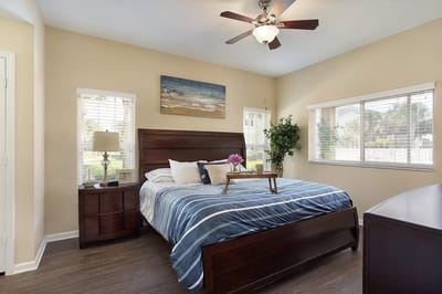 Brightly lit interior of a resident bedroom with amenities
