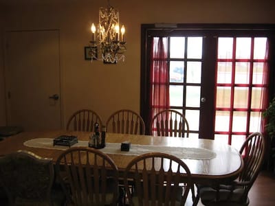 Dining area with a large table and chandelier