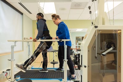 Resident undergoing physical therapy with assistance
