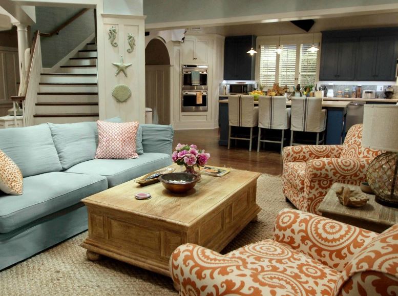 Bright common area with comfortable seating and a kitchen.