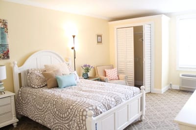 A cozy resident room with a bed and seating area